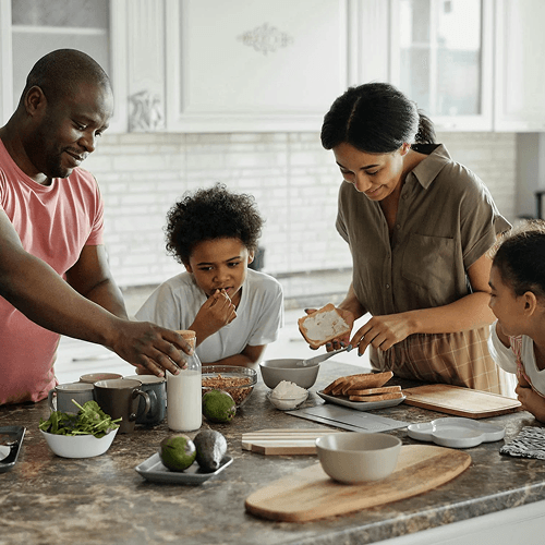 A family standing around a kitchen worksurface